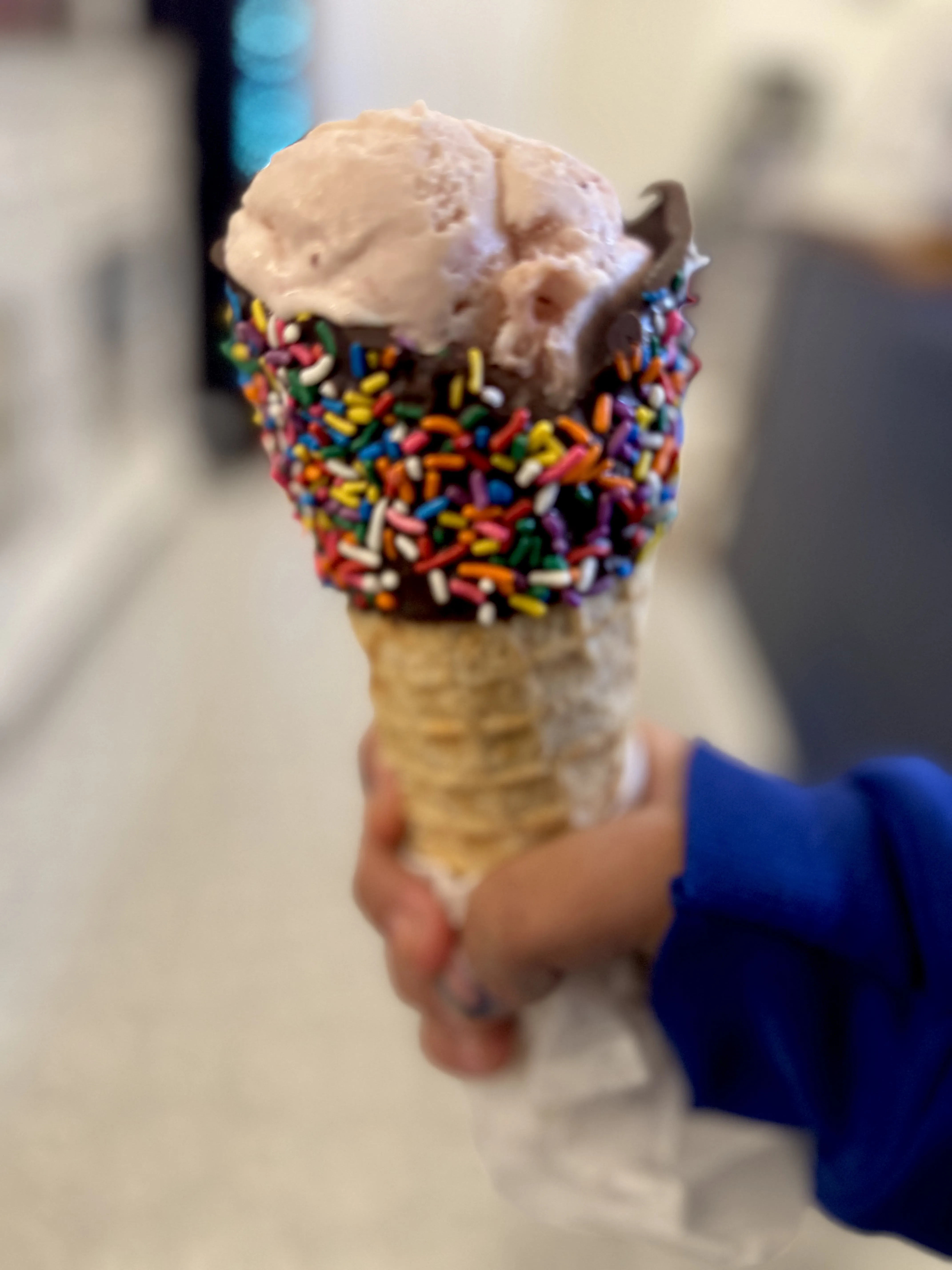 Chocolate dipped waffle cone with sprinkles